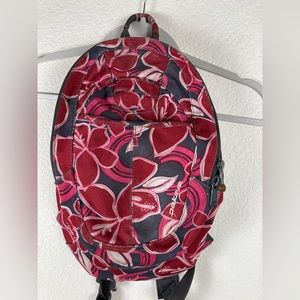 Dakine small cordura backpack, cherry colored flowers on a gray background